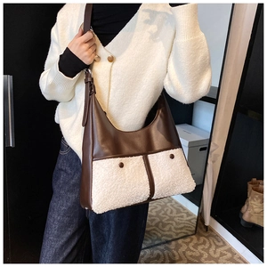 Detailed close-up of a stylish tote bag with white faux fur and brown leather contrast