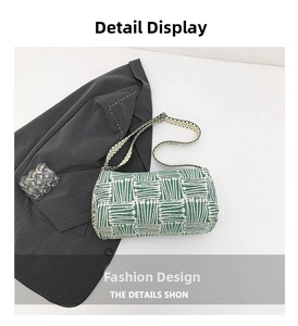 Detailed view of green and cream striped cylindrical shoulder bag with fabric texture