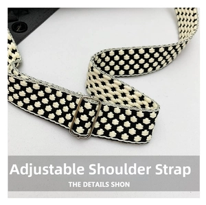 Close-up of adjustable woven shoulder strap with silver buckle for minimalist underarm bag