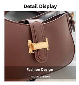 Macro detail of dark brown leather shoulder bag featuring a rectangular gold metal clasp