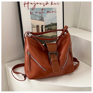 Detail view of caramel brown vintage tote with dual front zippers and silver buckle strap