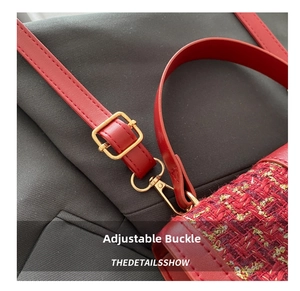 Detail of red tweed handbag showing adjustable shoulder strap with gold metal buckle
