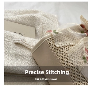 Detailed close-up of woven straw bag featuring floral lace embroidery and leather trim