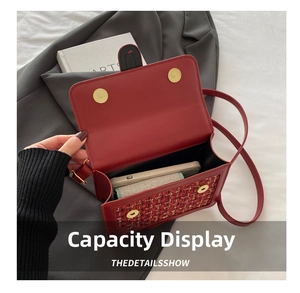 Detail view showing internal storage capacity of a red tweed shoulder bag with magnetic clasp