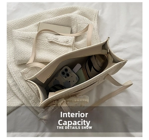 Interior view showing the large capacity of a woven tote bag with lace bow decoration