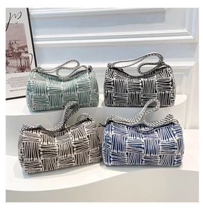 Detailed knit texture and geometric patterns on colorful cylinder bucket bags