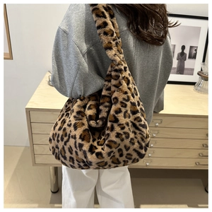 Detail of plush leopard print faux fur hobo bag for women in a stylish casual outfit