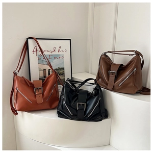 Vintage large leather tote bag in orange, black and brown with metal buckles