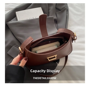 Interior capacity show of the dark brown leather shoulder bag with a phone inside