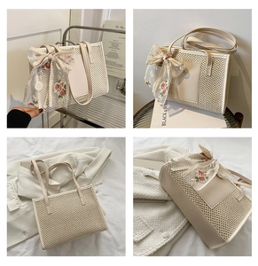 Detail of woven mesh texture and floral lace bow on cream straw tote bag
