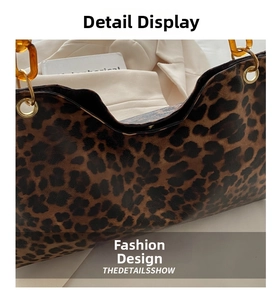 Detail of leopard print tote bag with amber resin chain and gold metallic hardware