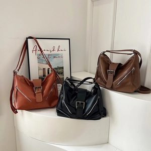 Three vintage chic hobo tote bags in black, dark brown, and caramel colors on pedestals