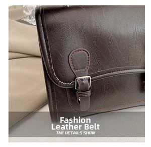Detail of dark brown leather texture and silver buckle on a vintage British style bag