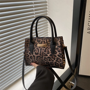 Fashionable leopard print square crossbody bag with dual handles and adjustable strap