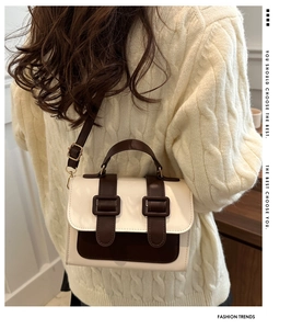 Retro academic style square bag in cream and brown finish worn with a cozy knit sweater