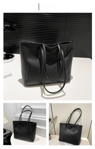 Detail view of a black vintage tote bag with sleek matte finish and long shoulder straps