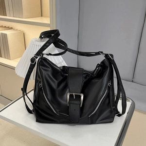 Retro biker style black leather tote bag with silver buckle and decorative zippers