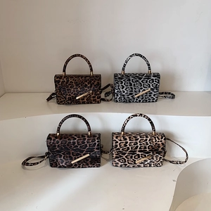 Leopard print crossbody bags in four colors with gold metal bars and shoulder straps