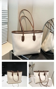 Detail of contrast stitching and brown handles on a minimalist cream tote bag