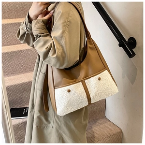 Detail of winter crossbody bag with brown leather and white plush fleece patchwork texture