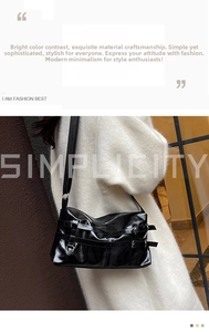 Close-up of black patent leather shoulder bag featuring silver buckle straps and glossy finish