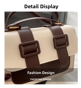 Detail of vintage beige leather crossbody bag featuring brown straps and gold buckles