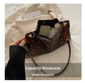 Leopard print tote bag interior showing large capacity with umbrella and wallet