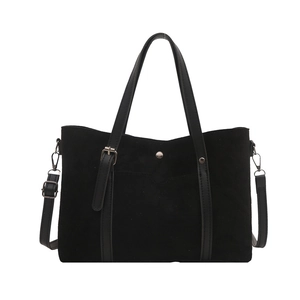 Retro black suede bucket bag with silver rivets and leather straps shown on white background