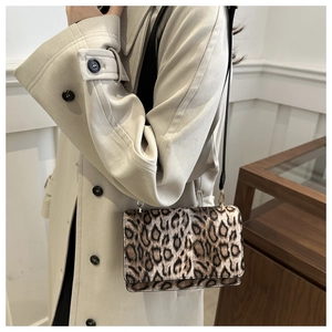 Detail of leopard print faux fur crossbody bag with chain and leather strap