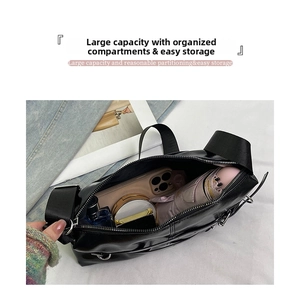 Spacious interior of a black leather tote showing smartphone, umbrella, and cosmetics