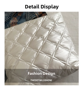Detail of white quilted tote bag featuring puffer texture and diamond stitch patterns