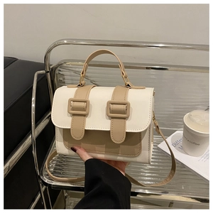 Detail of minimalist rectangular handbag with contrast stitching and dual buckles