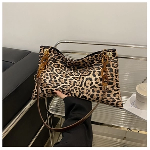 Detail of leopard print shoulder bag with amber acrylic chain and fuzzy texture