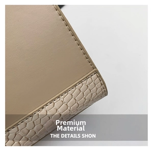 Detail of premium khaki leather handbag with textured embossed trim and fine stitching