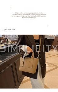 Detail of light brown lychee grain leather handbag with gold metal buckle and strap
