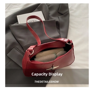 Intérieur spacieux d'un sac à bandoulière rouge foncé avec téléphone, portefeuille et maquillage