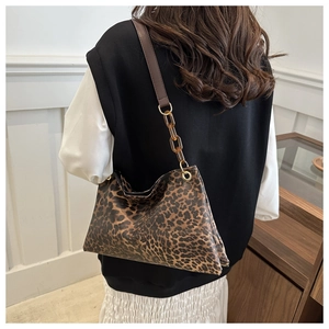 Detail of leopard print shoulder bag with resin chain strap and textured fabric