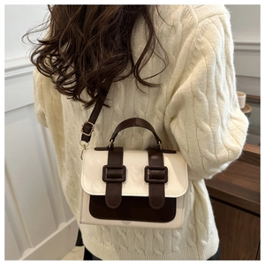 Detail of vintage square crossbody bag in contrast cream and brown faux leather