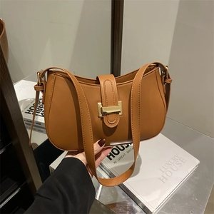 Brown vintage faux leather shoulder bag with gold buckle and curved silhouette