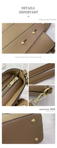 Détail de la quincaillerie dorée et du cuir grainé sur un sac seau marron avec pieds de base