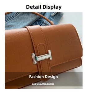 Close-up of brown crocodile pattern leather handbag with silver rectangular metal clasp