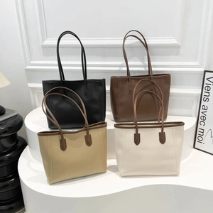 Minimalist leather tote bags in black, brown, and cream colors shown on a white background