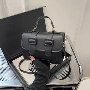 Modern color-block crossbody square bag in matte black with top handle and gold hardware