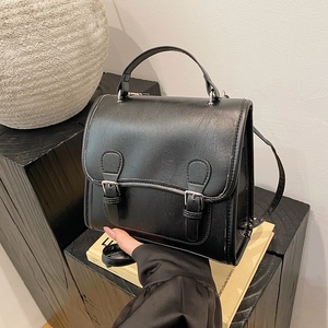 Retro black faux leather satchel with double buckles and top handle for classic style