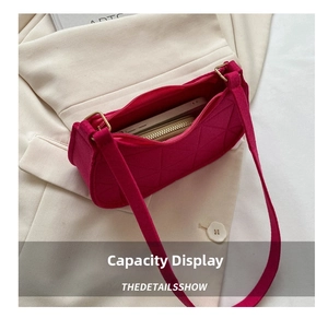 Internal capacity of the pink felt baguette bag showing a phone and long golden wallet