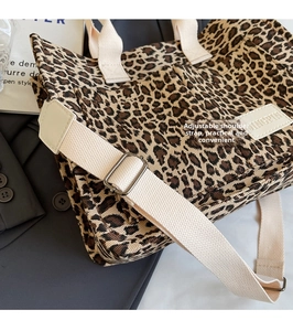 Leopard print canvas tote bag detail with adjustable wide strap and metal buckle