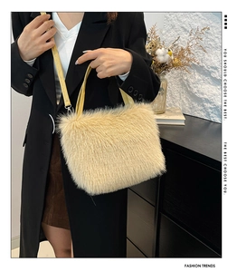 Detail of soft cream faux fur tote bag with bright yellow handles and detachable shoulder strap