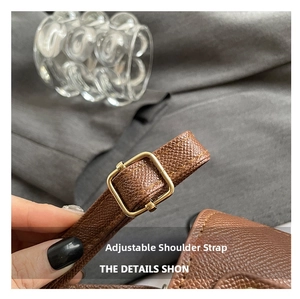 Detail of adjustable dark brown litchi grain leather strap with polished gold buckle