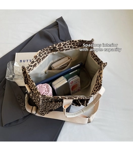 Detailed interior view of leopard canvas tote showing spacious compartments and zip pocket