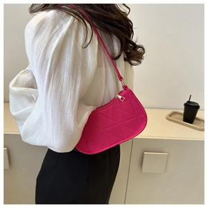 Close-up of fuchsia felt underarm bag with geometric triangular stitching and gold zipper